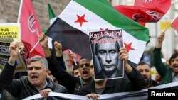 Pro-Islamist demonstrators, holding a Syrian opposition flag and a defaced poster of Russian President Vladimir Putin, shout slogans during an anti-Russian protest in Istanbul, Turkey, on November 27.