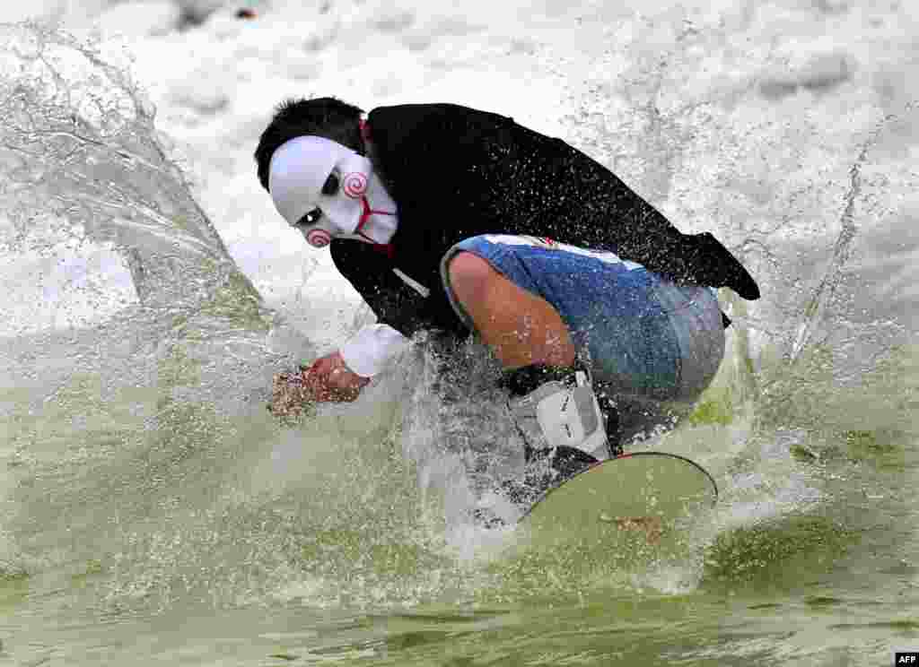 A snowboarder glides on the water during the &quot;Californication 6.0&quot; competition, marking the end of the winter season, in the Belarusian village of Silichi, some 45 kilometers outside of Minsk. (AFP/Viktor Drachev)