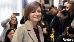 Moldovan President Maia Sandu reacts after casting her ballots in Chisinau during the country's presidential election and referendum on joining the European Union on October 20