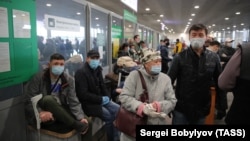 Kyrgyz migrant workers wait at Sheremetyevo International Airport ahead of a repatriation flight from Moscow to Bishkek on May 17.