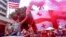 Protesters waive the Georgian and U.S. flags during a motorcade rally in Tbilisi on June 24.