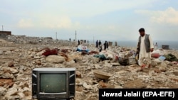 A man looks for his belongings after a heavy flood in the Charikar city of Parwan Province north of Kabul.