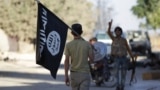 Syria -- A rebel fighter takes away a flag that belonged to Islamic State militants in Akhtarin village, after rebel fighters advanced in the area, in northern Aleppo Governorate, October 7, 2016