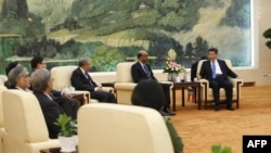 Chinese President Xi Jinping (R) meets with guests of the Asian Infrastructure Investment Bank at the Great Hall of the People in Beijing in October.