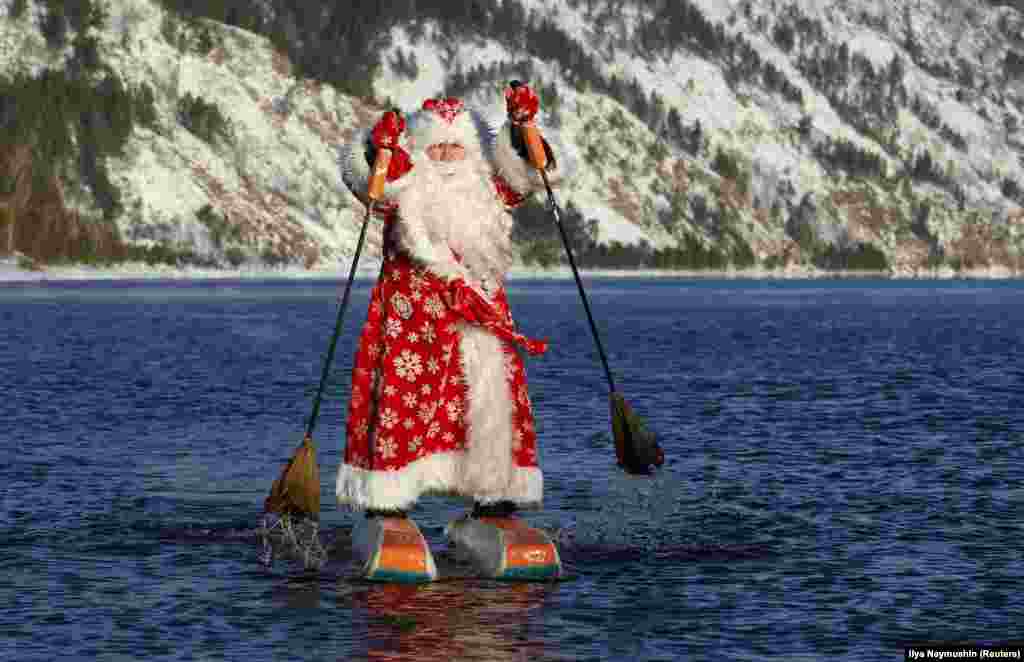 Nikolai Vasilyev, 64, dressed as Father Frost, the Russian equivalent of Santa Claus, water-skis along the Yenisei River outside the Siberian city of Krasnoyarsk. (Reuters/Ilya Naymushin)