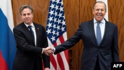 U.S. Secretary of State Antony Blinken (left) and Russian Foreign Minister Sergei Lavrov shake hands before a meeting on January 21, 2022, in Geneva. 