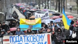 Demonstrators against the tax changes march during a protest in Lviv on November 29.