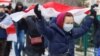 BELARUS - Opposition supporters carry historical white-red-white flags of Belarus as they attend a rally to reject the presidential election results in Minsk, 13dec2020