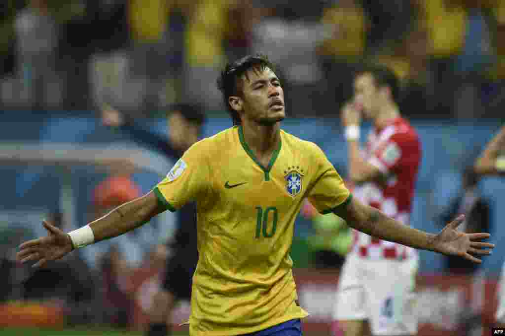 Brazil -- Brazil's forward Neymar celebrates after scoring a penalty during a Group A football match between Brazil and Croatia at the Corinthians Arena in Sao Paulo during the 2014 FIFA World Cup on June 12, 2014