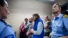 Kosovo police officers stand guard as the convicted plotters are sentenced in Pristina on May 18. 