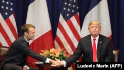 U.S. -- French President Emmanuel Macron (L) shakes hands with U.S. President Donald Trump at the start of a bilateral meeting in New York, September 24, 2018