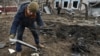 A man inspects parts of a kamikaze drone at the site of a residential area hit by a Russian drone strike in Zaporizhzhya, Ukraine, on November 25.