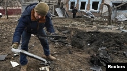 A man inspects parts of a kamikaze drone at the site of a residential area hit by a Russian drone strike in Zaporizhzhya, Ukraine, on November 25.