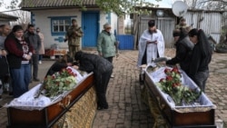 The funeral procession for brothers Oleh and Kostyantyn Zaliznyak passes through Petrove in Ukraine's central Kirovohrad region.