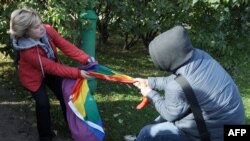 A rights activist (left) is set upon by against an antigay protester during a gay-pride event in St. Petersburg. Russia's "gay propaganda" law has been blamed for unleashing a wave of homophobia across the country.