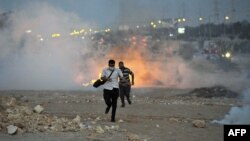 Egyptian supporters of the deposed president, Muhammad Morsi, run from a fire during clashes with security forces in Six October City in Giza, south of Cairo, on August 2.