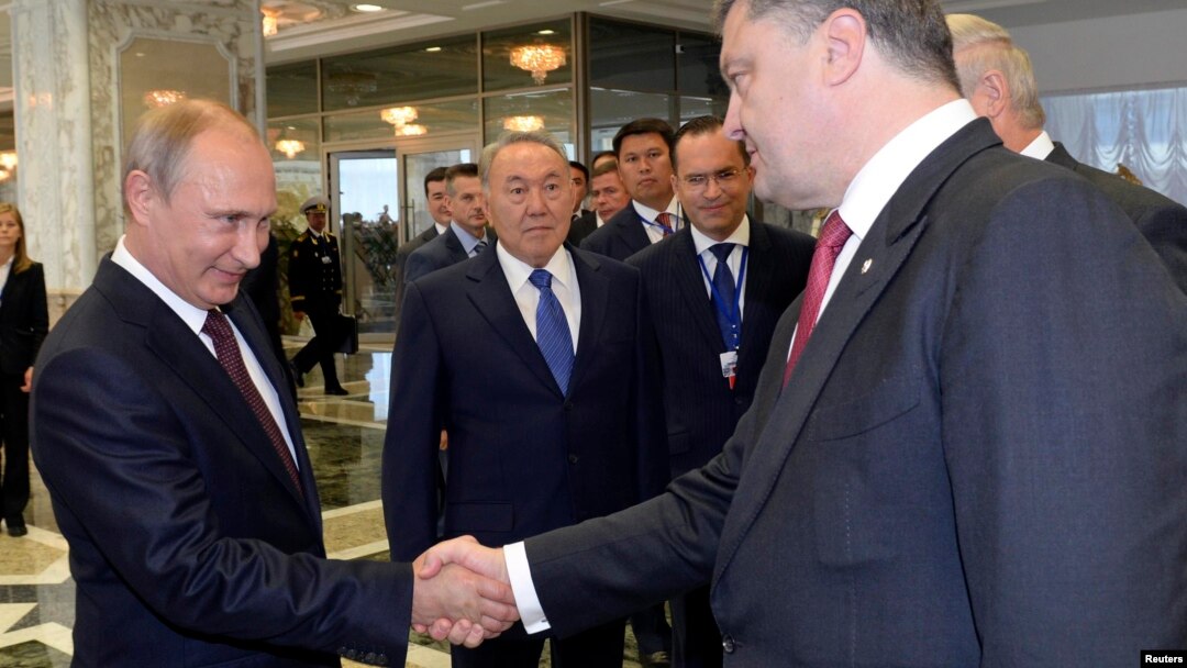 Russian President Vladimir Putin (left) shakes hands with Ukrainian President Petro Poroshenko ahead of talks in Minsk on August 26.