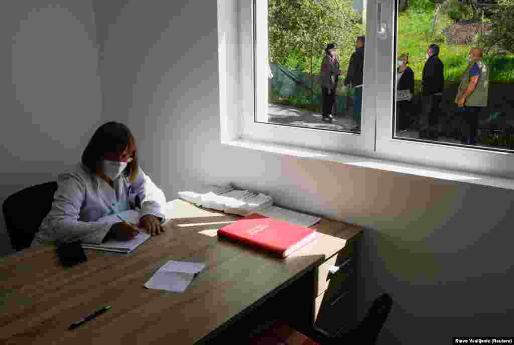 A health-care worker fills out paperwork during the village expedition.&nbsp;