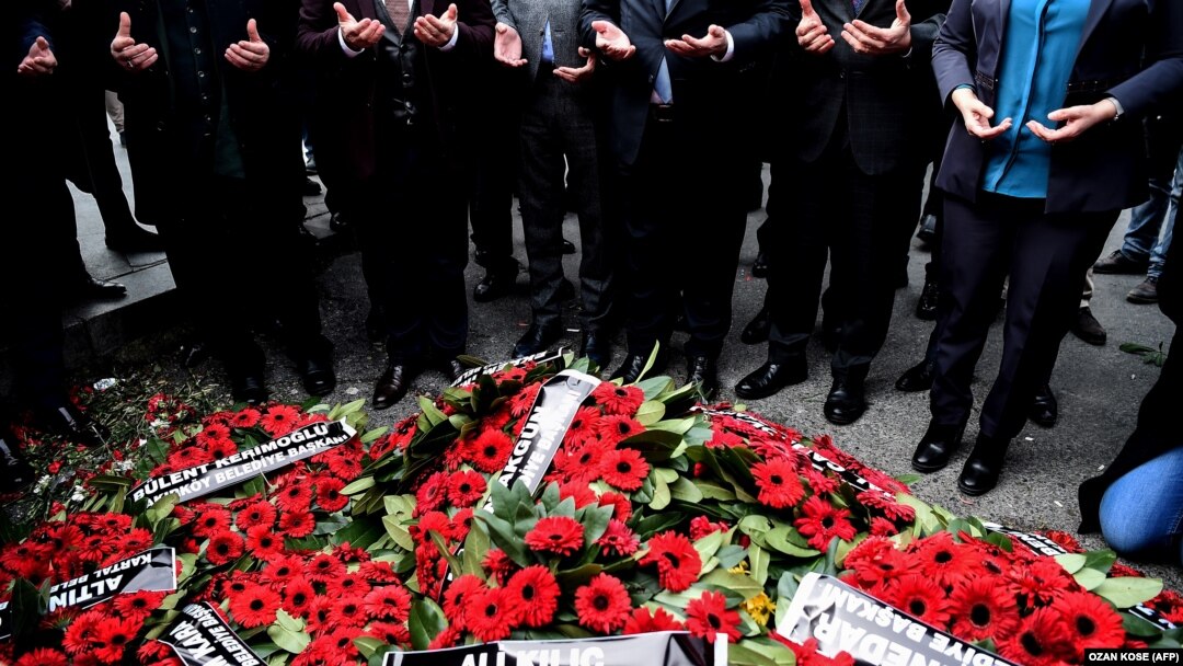 Mourners pray after laying wreaths near the site of the Reina nightclub massacre in Istanbul, which left 39 people dead. 