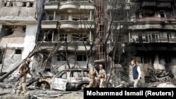 Afghan security forces inspect the site of the July 28 attack in Kabul.