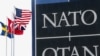 National flags of NATO members flutter at alliance's headquarters in Brussels.