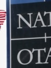 National flags of NATO members flutter at alliance's headquarters in Brussels.