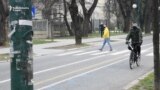 Bosnia and Herzegovina, Sarajevo, A man on a bicycle on Wilson's Promenade, April, 2021