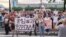 Protesters hold a banner reading "I'm/We're Furgal" as they attend a mass rally in support of Governor Sergei Furgal in Khabarovsk on July 16.