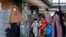 Families evacuated from Kabul, Afghanistan, walk through the terminal to board a bus after they arrived at Washington Dulles International Airport, in Chantilly, Va., Sept. 1, 2021