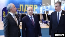 Russia - Russian President Vladimir Putin, accompanied by State Duma speaker Vyacheslav Volodin (left), visits an exhibition in Moscow, April 24, 2026.