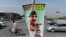 FILE: A cyclist rides past a banner bearing the image of former Inter-Services Intelligence (ISI) Chief Lt. General Zaheerul Islam in Islamabad, April 2014.