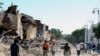 Haiti - Locals walk in a destroyed street in Port-au-Prince, on January 14, 2010, following the devastating earthquake that rocked Haiti on January 12