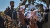 A Taliban fighter stands guard as Afghan women shout slogans during a protest rally near the Pakistani Embassy in Kabul on September 7.
