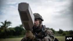 A French soldier wields an anti-drone gun during a training mission in Kourou, French Guiana, on March 2.