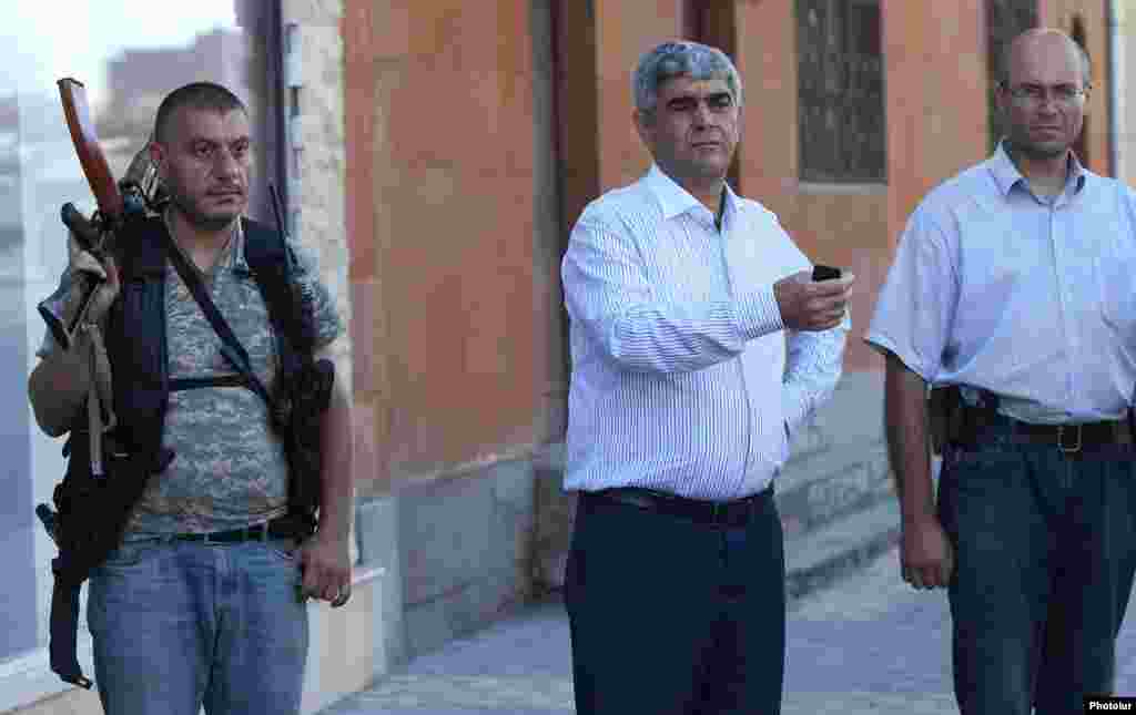 Armenia - Retired army General Vitaly Balasanian (C) is flanked by Varuzhan Avetisian (R) and another member of an armed group that seized a police station in Yerevan, 23Jul2016.