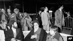 FRANCE -- file -- Ayatollah Ruhollah Khomeini talks briefly with reporters at Roissy-Charles de Gaulle Airport, Jan. 31, 1979, 