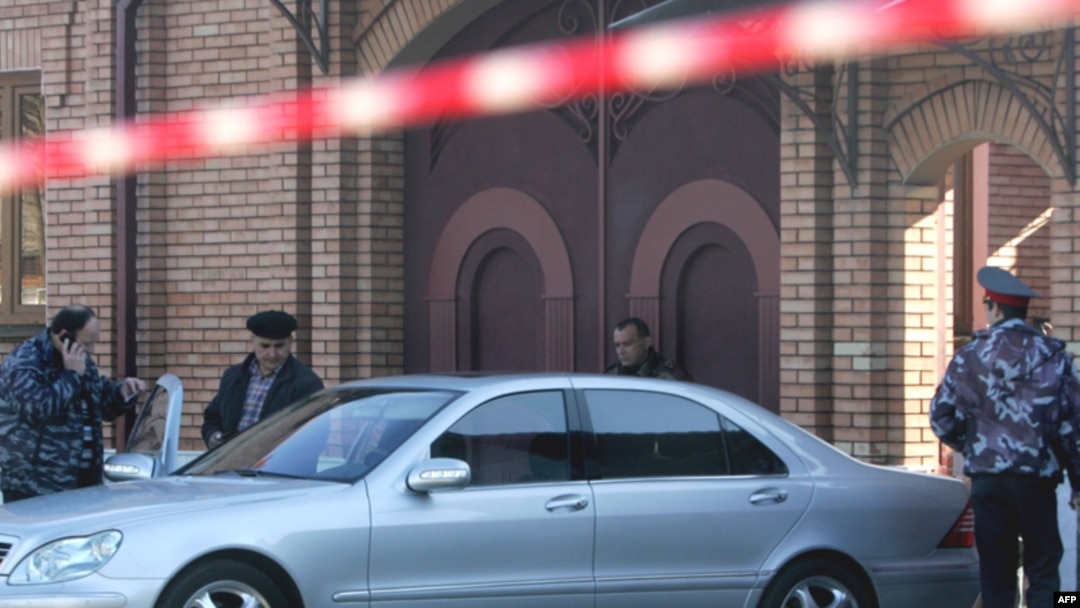 Forensics experts examine the crime scene and car of Vladikavkaz Mayor Vitaly Karayev
