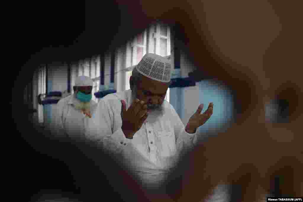 Muslim worshippers practice physical distancing as they offer prayers in Karachi, Pakistan, on May 22 ahead of the Eid al-Fitr festival at a mosque.