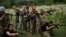 Ukraine Nationalist Youth Camp-In this July 29, 2018 photo, young participants of the "Temper of will" summer camp, organized by the nationalist Svoboda party, practice tactical formations with AK-47 assault riffles in a village near Ternopil, Ukraine. (A