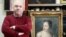 Russian art collector Aleksandr Khochinsky stands next to what Poland believes is the 18th-century painting Girl With A Dove.