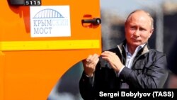 Russian President Vladimir Putin poses next to a Kamaz truck during the opening ceremony for a bridge linking the annexed Crimean Peninsula to Russia, in Kerch on May 15.