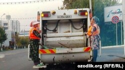 Uzbekistan - Uzbek women working with collecting garbage car, undated