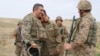 Nagorno-Karabakh -- An Armenian officer hugs a soldier during heavy fihting with Azerbaijani forces along the Karabakh "line of contact," September 28, 2020.