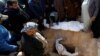 Mourners gather around the body of a demonstrator who was killed at an anti-government protest overnight, during a funeral in Najaf on February 6.