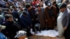 Mourners gather around the body of a demonstrator who was killed at an anti-government protest overnight, during the funeral in Najaf, February 6, 2020