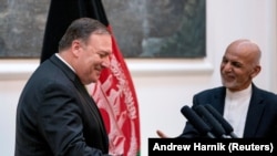 Afghan President Ashraf Ghani and Secretary of State Mike Pompeo shake hands following a news conference at the Presidential Palace in Kabul, Afghanistan July 9, 2018