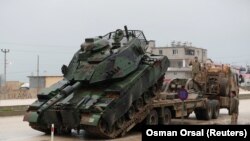 A Turkish military tank arrives at an army base in the border town of Reyhanli near the Turkish-Syrian border in Hatay province, January 17, 2018