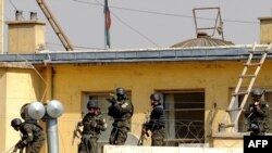 Afghan commandos try to enter the Justice Ministry building, which was attacked by militants in Kabul.