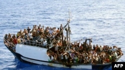 A photo released by French authorities of a fishing boat carrying around 300 illegal migrants in the Mediterranean Sea before being intercepted in September 2008.