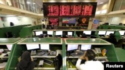 Stock-market employees work at Tehran's Stock Exchange on January 17.